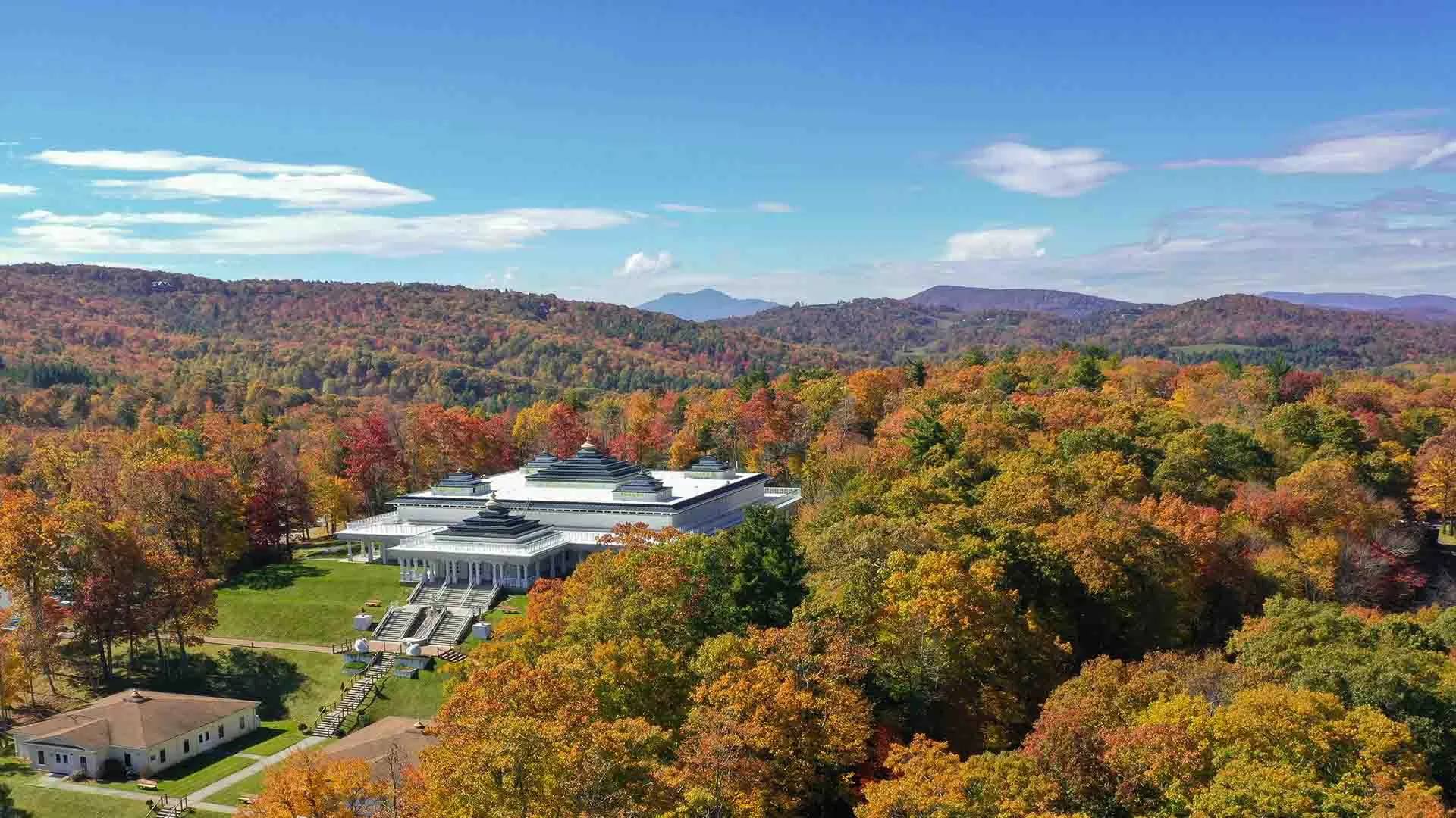 An autumn aerial view of a retreat among mountain forests