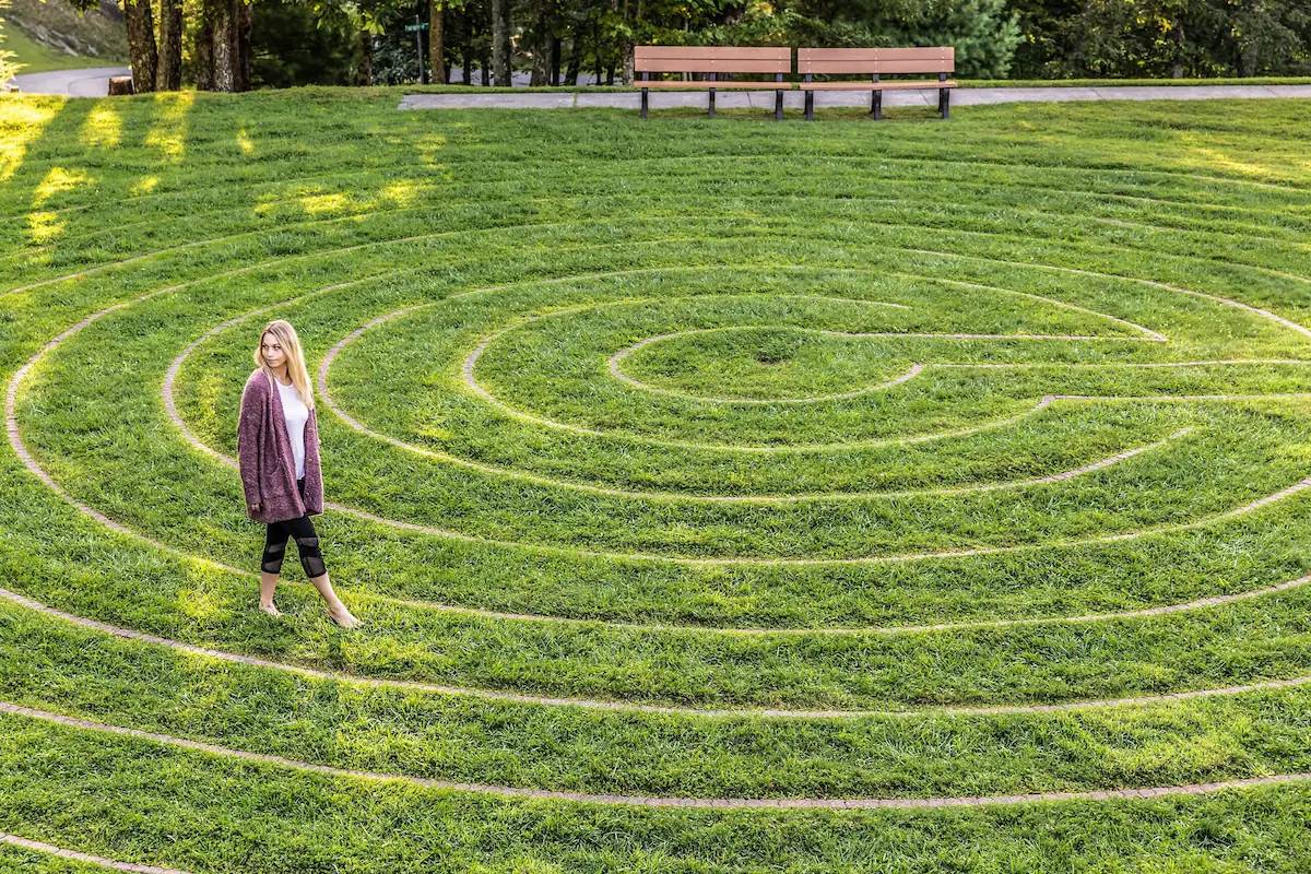 A guest walking a grass labyrinth at a retreat